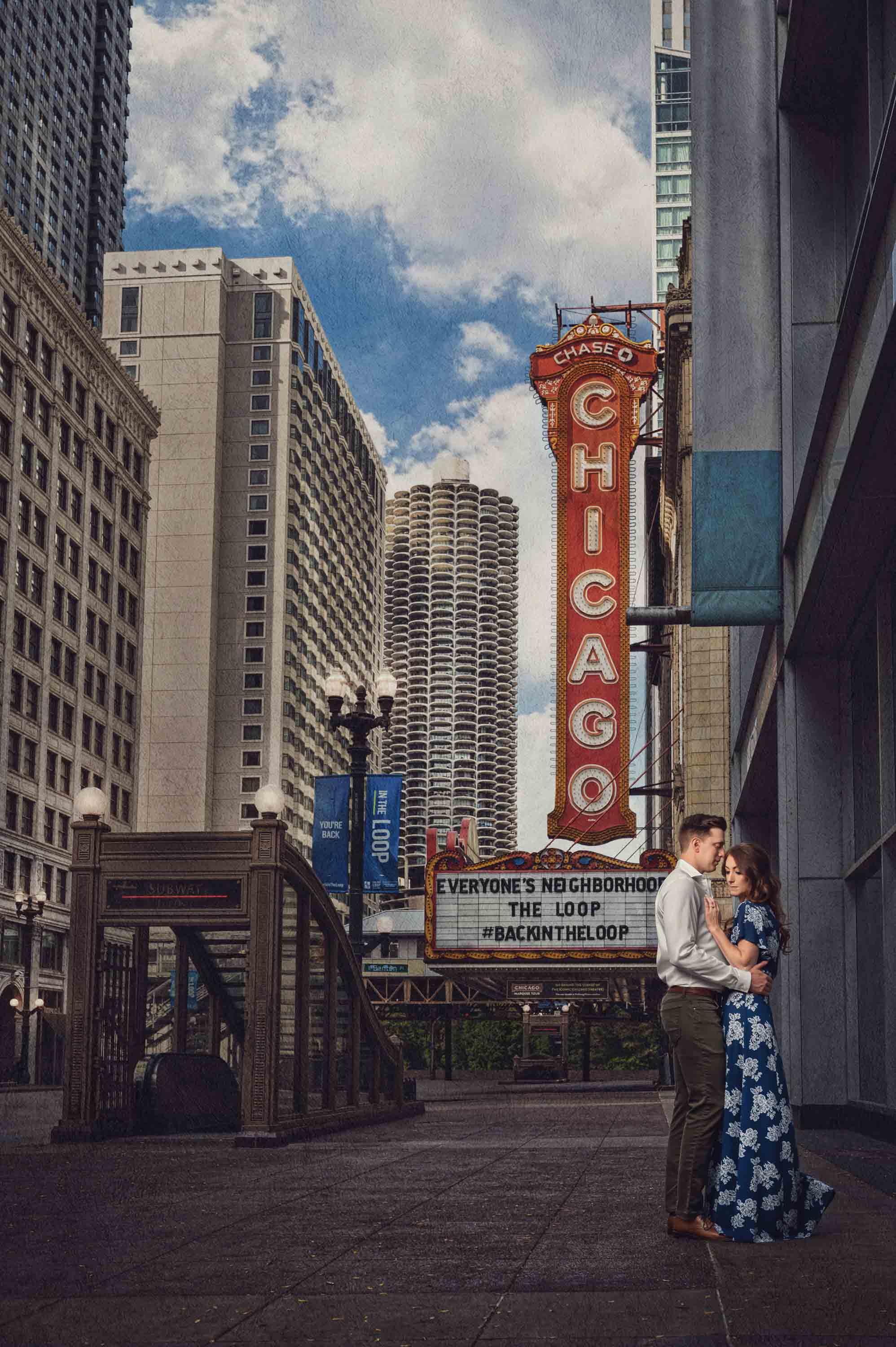 Couple beneath the Chicago Theatre sign