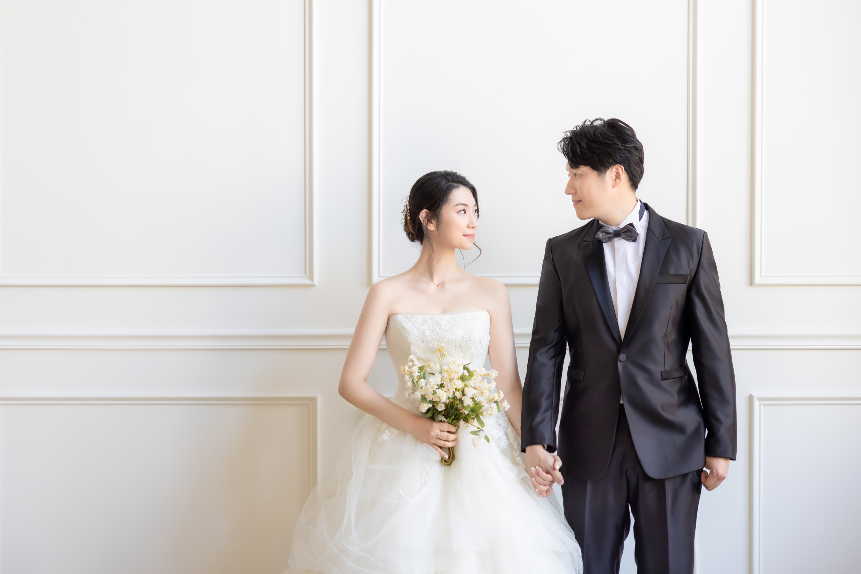 Couple in wedding attire photographed in the studio