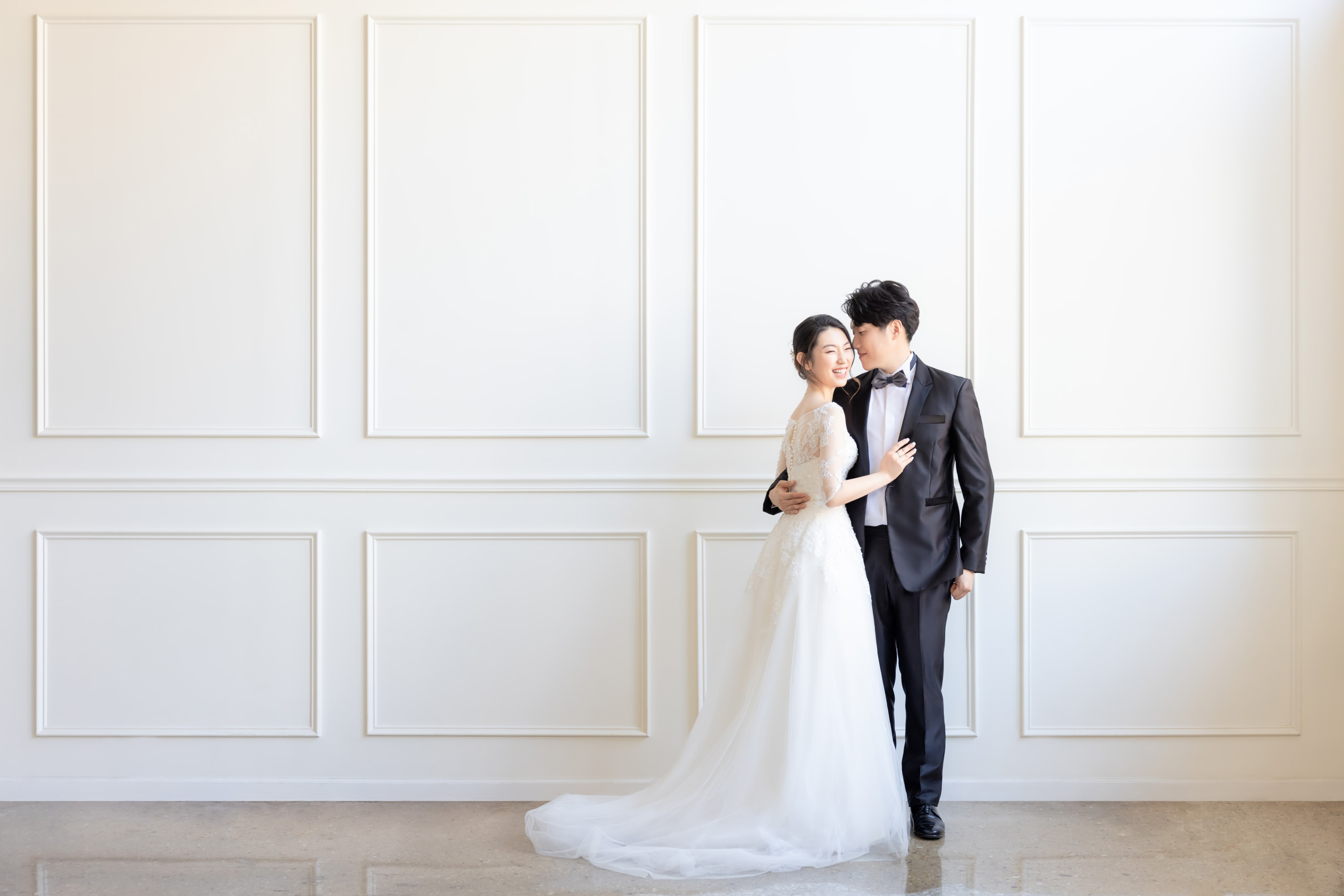Couple in wedding clothing in a bright studio