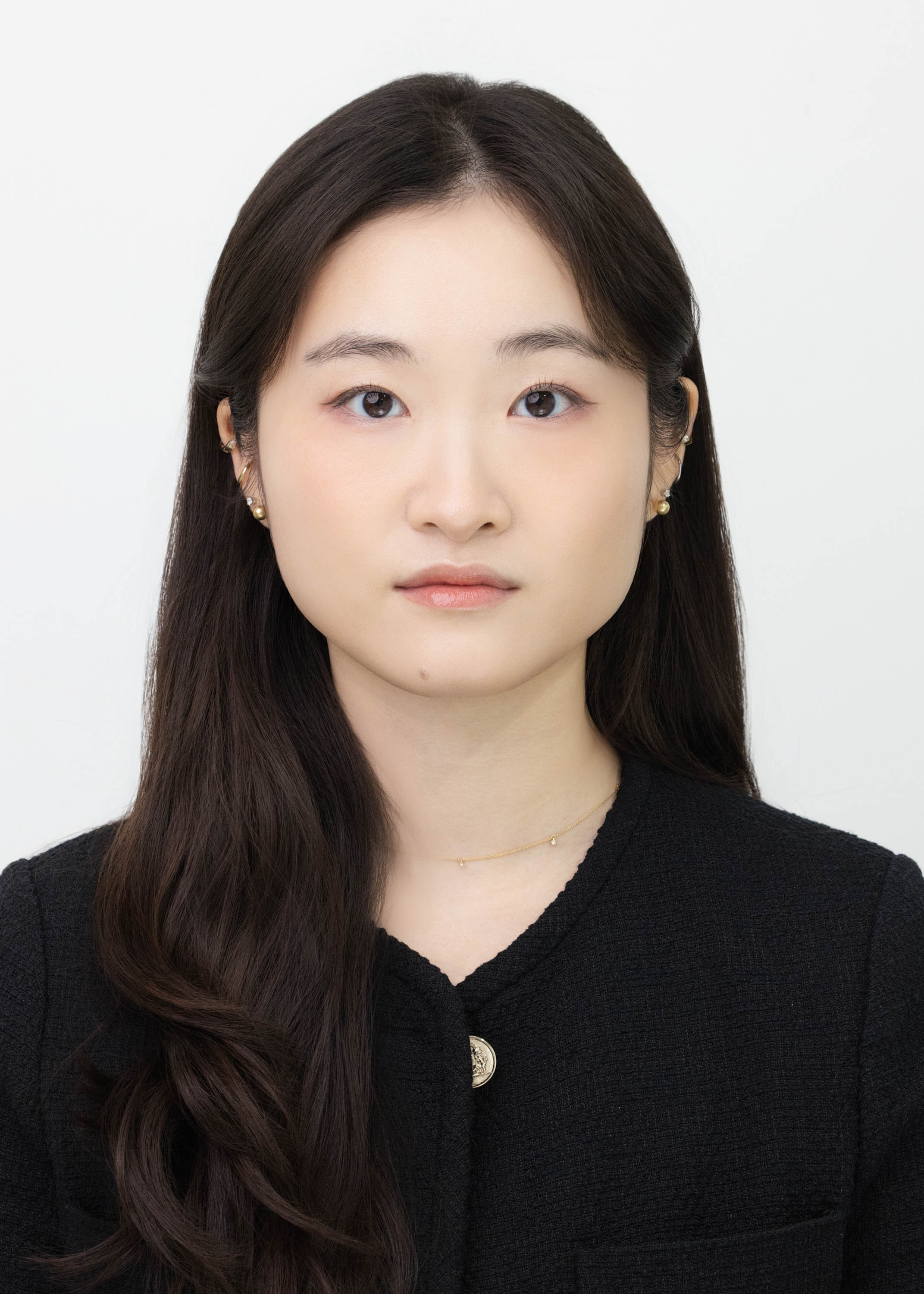 Straight-on identification portrait against a light background