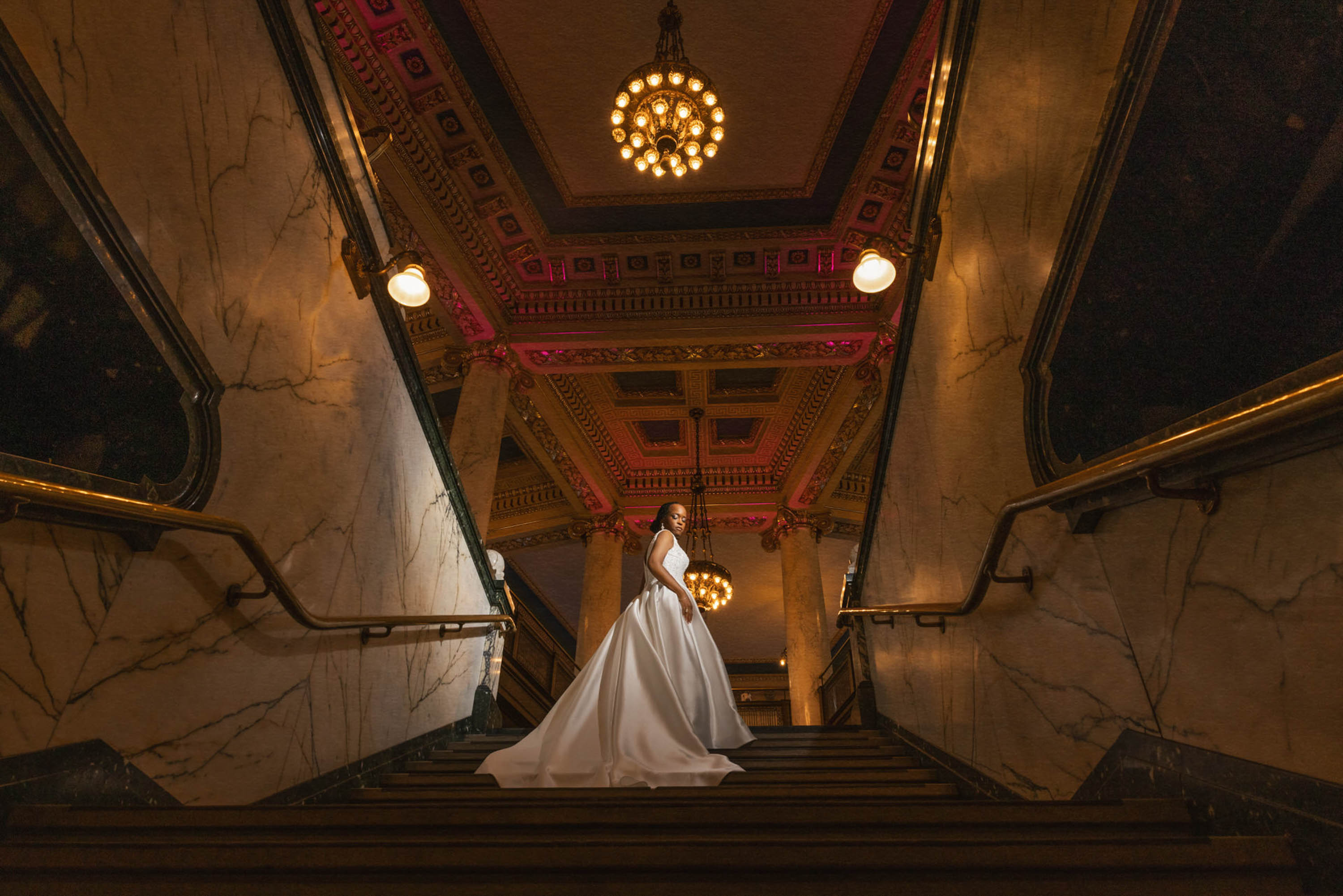 Bride on a grand staircase at a wedding venue