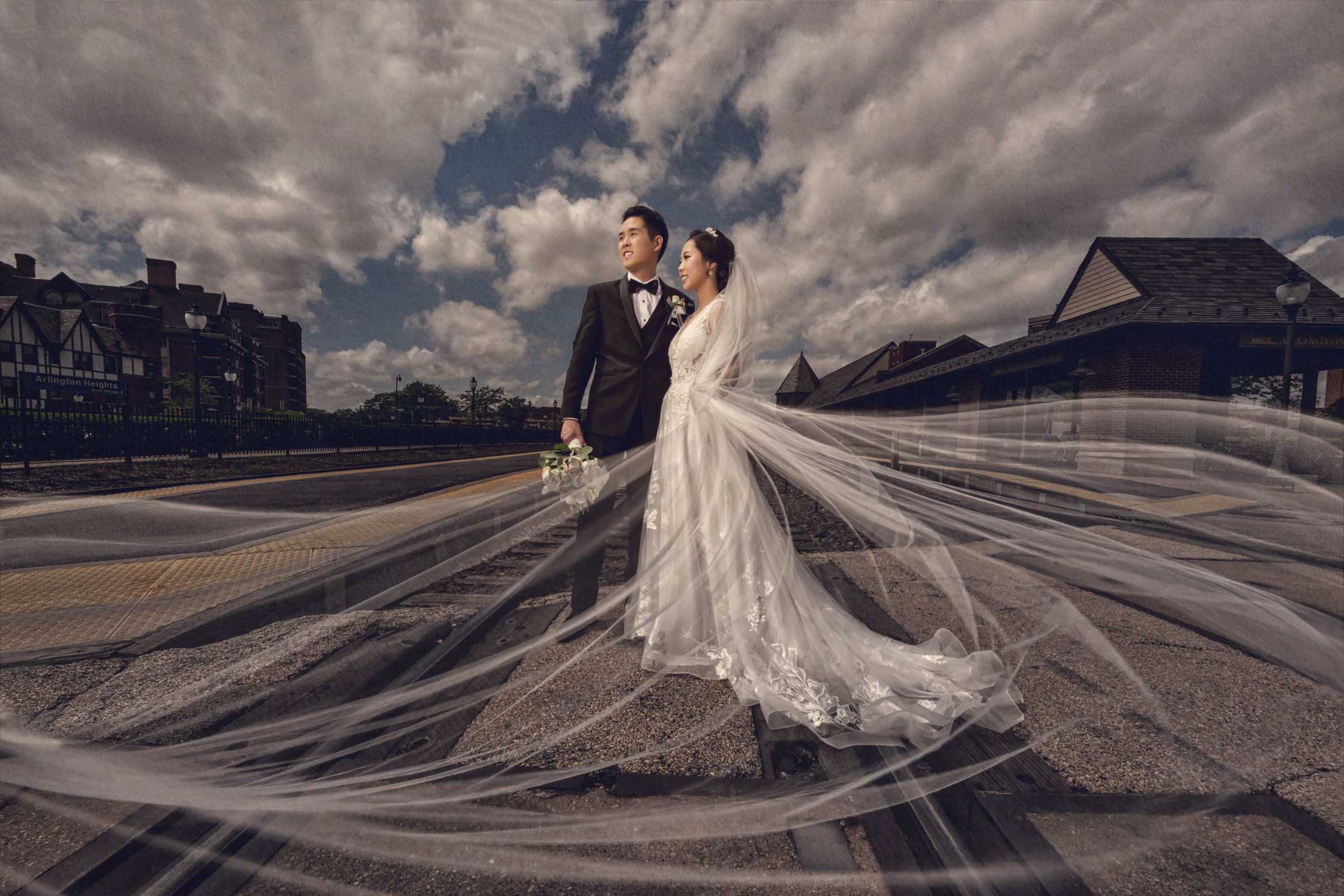 Couple in wedding attire photographed together outdoors